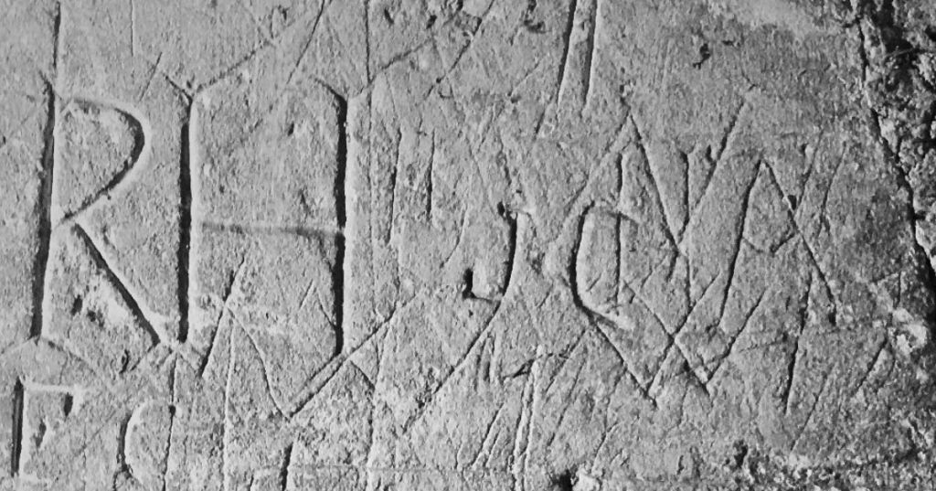 Medieval graffiti carvings in Winchester showing historic symbols and markings